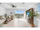 Living room with sliding glass doors leading to a patio overlooking a lake at 2265 Alee Ln, Wesley Chapel, FL 33543