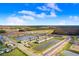 Aerial view of townhouses next to a lake, highlighting the community's location at 2265 Alee Ln, Wesley Chapel, FL 33543