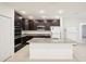 Modern kitchen with island, stainless steel appliances, and granite countertops at 4013 Chadwick Ave, Spring Hill, FL 34609