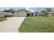 House exterior with a two-car garage and large front yard at 4013 Chadwick Ave, Spring Hill, FL 34609
