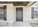 Dark brown front door with sidelights and shutters at 4013 Chadwick Ave, Spring Hill, FL 34609