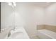 Clean bathroom featuring a double vanity and bathtub at 4013 Chadwick Ave, Spring Hill, FL 34609