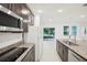 Modern kitchen with island, stainless steel appliances, and backyard access at 4013 Chadwick Ave, Spring Hill, FL 34609