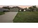 Front view of a two-car garage house with a well-maintained lawn at 4013 Chadwick Ave, Spring Hill, FL 34609
