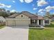 Two-story house with two-car garage and landscaping at 4013 Chadwick Ave, Spring Hill, FL 34609