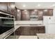 Dark wood cabinets and granite countertops in this modern kitchen at 4013 Chadwick Ave, Spring Hill, FL 34609