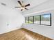 Well-lit bedroom with hardwood floors, window and ceiling fan at 3044 Red Oak Ct # 204, Palm Harbor, FL 34684