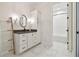 Clean bathroom with white cabinets and marble floors at 17318 Hanna Rd, Lutz, FL 33549