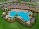 Aerial view of resort-style community pool with lounge chairs and shade structures at 18023 Canopy Pl, Bradenton, FL 34211