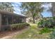 Screened patio and walkway in a tree-filled backyard at 4623 Oak Hill Ter # 32, Sarasota, FL 34232