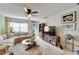 Bright living room with comfy sectional sofa, large TV, and coastal decor at 5286 81St N St # 4, St Petersburg, FL 33709