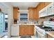 Modern kitchen with white appliances and wood cabinets at 5286 81St N St # 4, St Petersburg, FL 33709