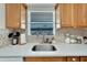 Kitchen sink with white countertop and wood cabinets at 5286 81St N St # 4, St Petersburg, FL 33709