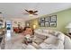 Spacious living area with sectional sofa, dining area view, and ceiling fan at 5286 81St N St # 4, St Petersburg, FL 33709