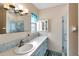 Clean bathroom with light blue vanity, tiled shower, and mosaic accents at 5286 81St N St # 4, St Petersburg, FL 33709
