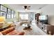 Bright living room with comfy sectional sofa, large TV, and coastal decor at 5286 81St N St # 4, St Petersburg, FL 33709