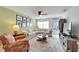 Bright living room with comfy sectional sofa, large TV, and coastal decor at 5286 81St N St # 4, St Petersburg, FL 33709