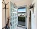 Condo entryway with a teal door and coat rack at 5286 81St N St # 4, St Petersburg, FL 33709