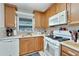 Updated kitchen with white appliances and wood cabinets at 5286 81St N St # 4, St Petersburg, FL 33709
