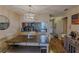 Bright dining room with kitchen view, wood floors, and a farmhouse table at 3507 59Th W Ave # 4020, Bradenton, FL 34210