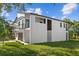 Modern home showcasing clean lines and a spacious lawn at 7639 Gulf Way, Hudson, FL 34667