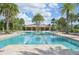 Community pool with lounge chairs and a shaded seating area at 11836 Meadowgate Pl, Bradenton, FL 34211