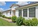 White house exterior with dark-framed windows and neatly trimmed landscaping at 11836 Meadowgate Pl, Bradenton, FL 34211