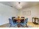 Modern dining room with round table and blue chairs, near sliding doors at 9308 Pebble Creek Dr, Tampa, FL 33647