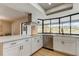 Modern kitchen with white cabinets, stainless steel appliances, and a corner window at 9308 Pebble Creek Dr, Tampa, FL 33647