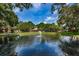 Serene pond with fountain, lush landscaping and clubhouse view at 2650 Countryside Blvd # F110, Clearwater, FL 33761