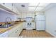 Bright kitchen features wood cabinets, tile floors, and stainless steel appliances at 2650 Countryside Blvd # F110, Clearwater, FL 33761
