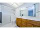Updated bathroom with wood vanity, quartz countertop and a shower/tub combo at 2650 Countryside Blvd # F110, Clearwater, FL 33761