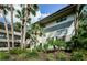 Condo building exterior showcasing landscaping and palm trees at 2650 Countryside Blvd # F110, Clearwater, FL 33761
