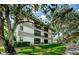Building exterior showcasing landscaping and tree lined street at 2650 Countryside Blvd # F110, Clearwater, FL 33761