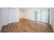 Bedroom with wood-look flooring and access to a private balcony at 2650 Countryside Blvd # F110, Clearwater, FL 33761