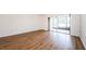 Living room featuring laminate wood floors and access to a patio at 2650 Countryside Blvd # F110, Clearwater, FL 33761