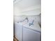 Bright laundry room with washer and dryer, and shelving at 2650 Countryside Blvd # F110, Clearwater, FL 33761