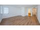 Spacious bedroom with wood-look flooring and access to the bathroom at 2650 Countryside Blvd # F110, Clearwater, FL 33761