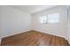 Bright bedroom with wood-look flooring and a large window at 2650 Countryside Blvd # F110, Clearwater, FL 33761