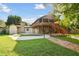 House with a large backyard, pool, and brick pathway at 10213 Newport Cir, Tampa, FL 33612