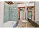 Bathroom featuring a jacuzzi tub, granite countertop, and tiled walls at 10213 Newport Cir, Tampa, FL 33612