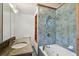 Bathroom with granite vanity and blue tile shower/tub at 10213 Newport Cir, Tampa, FL 33612