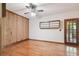 Bright bedroom with wood floors, wood wall accents, and built-in shelving at 10213 Newport Cir, Tampa, FL 33612