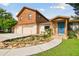 Two-story house with stone accents, blue door and a charming pond at 10213 Newport Cir, Tampa, FL 33612