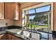 Kitchen sink with a window overlooking the front yard and driveway at 10213 Newport Cir, Tampa, FL 33612