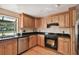 Modern kitchen with stainless steel appliances and wood cabinets at 10213 Newport Cir, Tampa, FL 33612