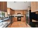 Spacious kitchen featuring light wood cabinets, dark granite countertops, and stainless steel appliances at 10213 Newport Cir, Tampa, FL 33612