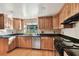 Spacious kitchen with wood cabinets, granite counters, and stainless steel appliances at 10213 Newport Cir, Tampa, FL 33612