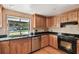 Kitchen with wood cabinets, granite countertops, and stainless steel appliances at 10213 Newport Cir, Tampa, FL 33612