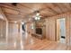 Large living room with hardwood floors, wood walls and a stone fireplace at 10213 Newport Cir, Tampa, FL 33612